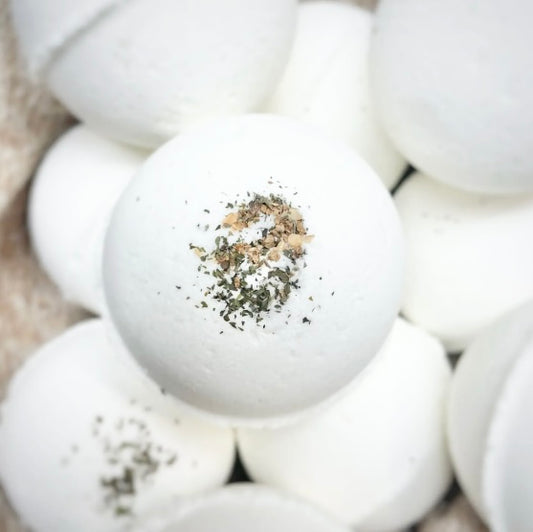A close-up image of a single bath bomb, surrounded by a group of bath bombs. 